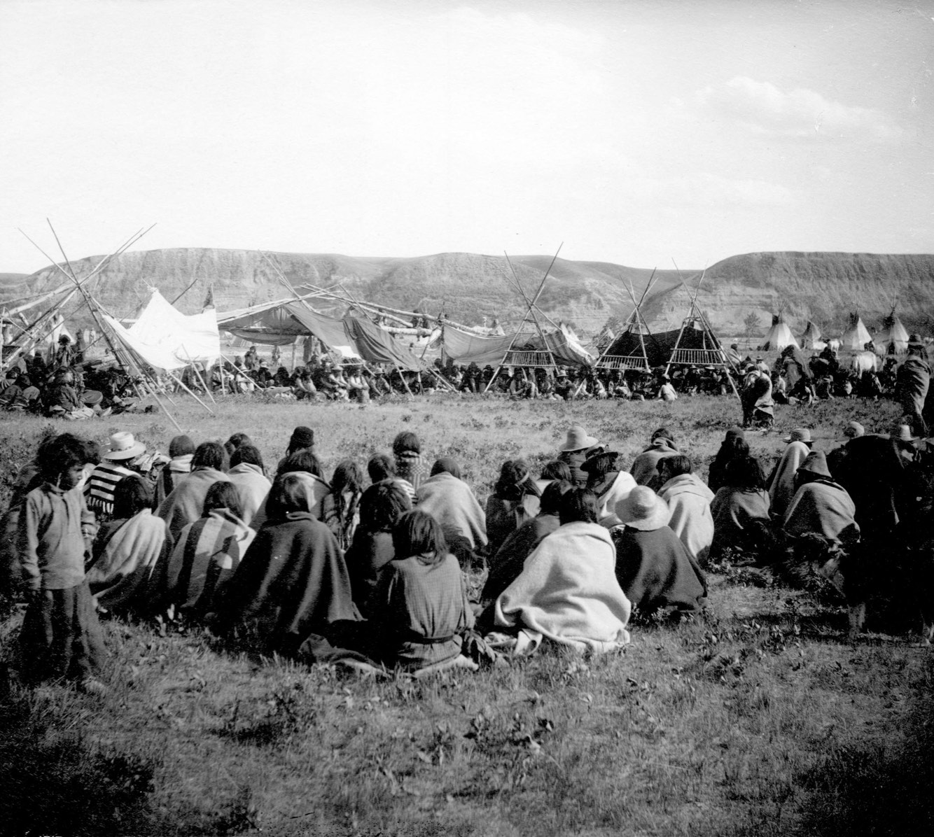 Policies in Canada made it illegal to engage in First Nations cultural and ceremonies during the early part of the 20th century. Today individuals and communities are actively engaged in reclaiming their traditional practices. This picture was taken at a Sun Dance Ceremony of the Blackfeet Nation, Gleichen, NWT, just prior to the ceremony being outlawed.