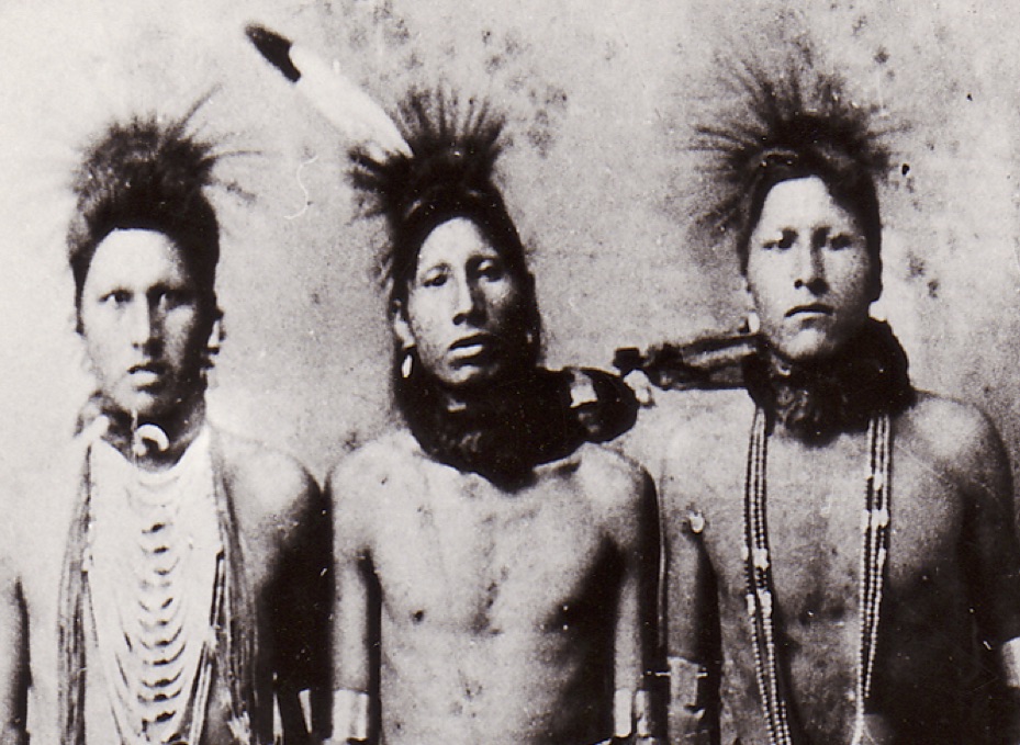 Blackfoot Men in traditional regalia celebrating a way of life that would face hardships from newcomers.